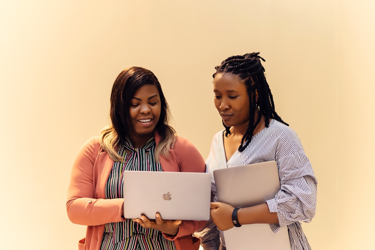 African IT team collaborating near a laptop